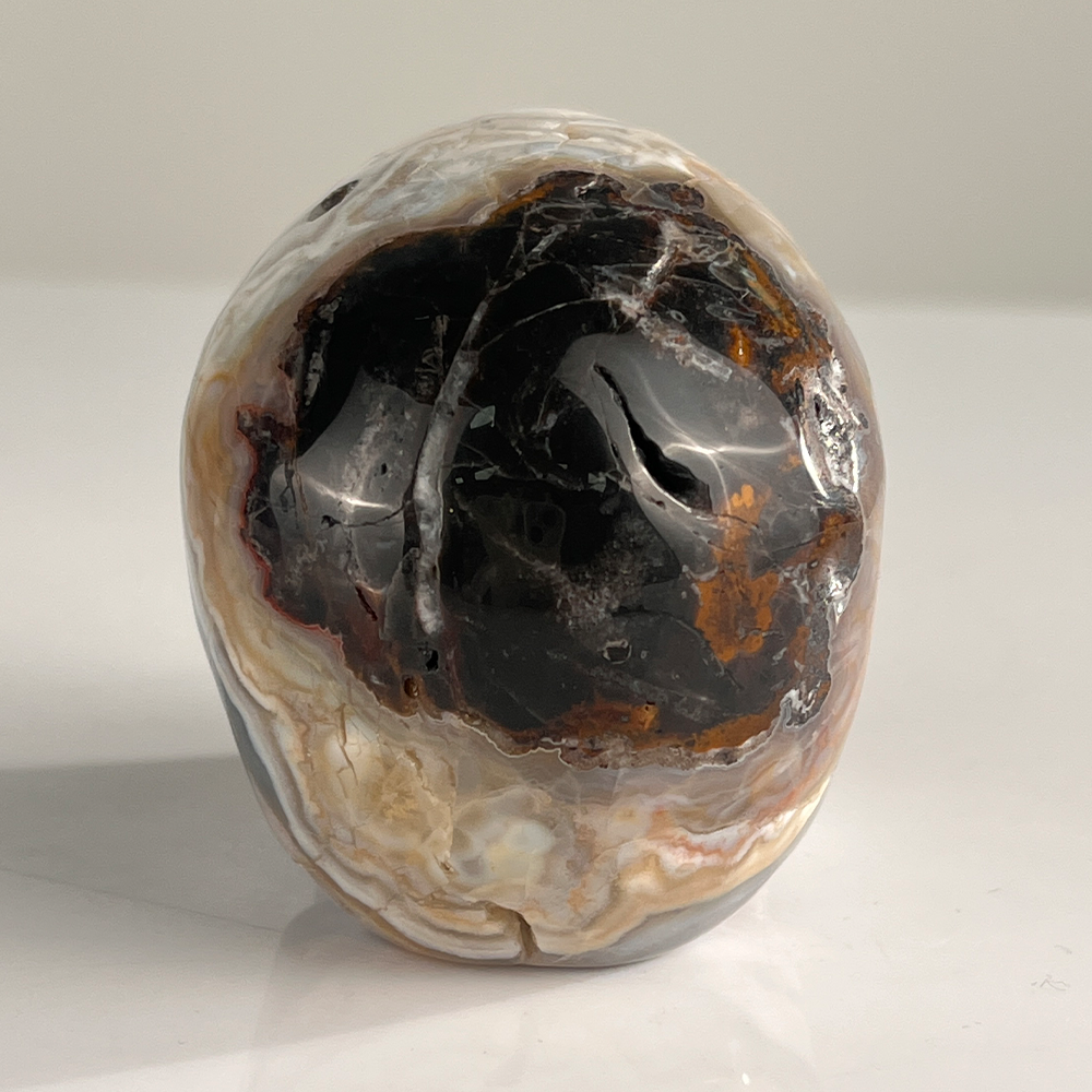 Back view of a 3-inch Red Crazy Lace Agate human skull carving