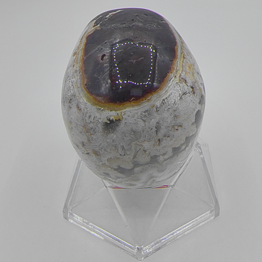 Back view of a 3-inch Red Crazy Lace Agate human skull carving