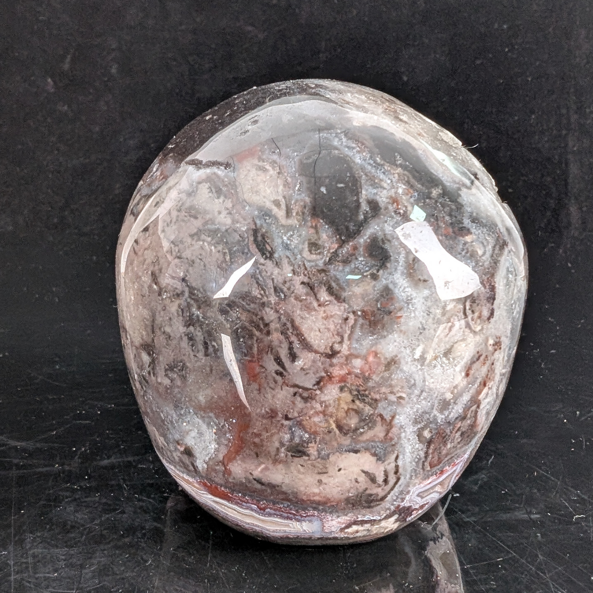 Back view of a 4.5-inch Red Crazy Lace Agate human skull carving