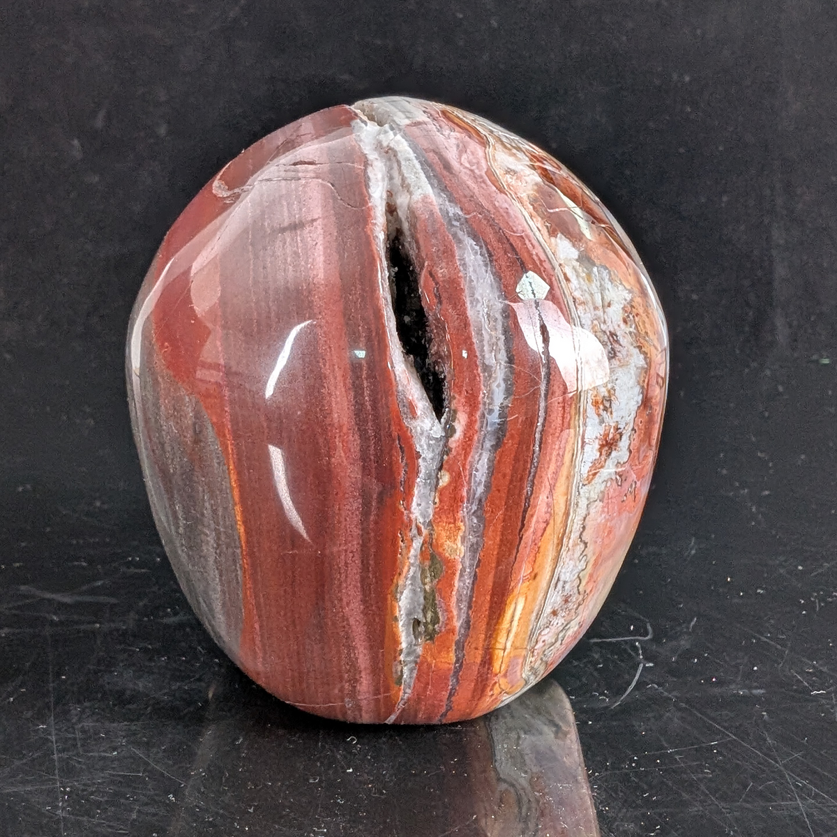 Back view of a 4.5-inch Red Crazy Lace Agate human skull carving