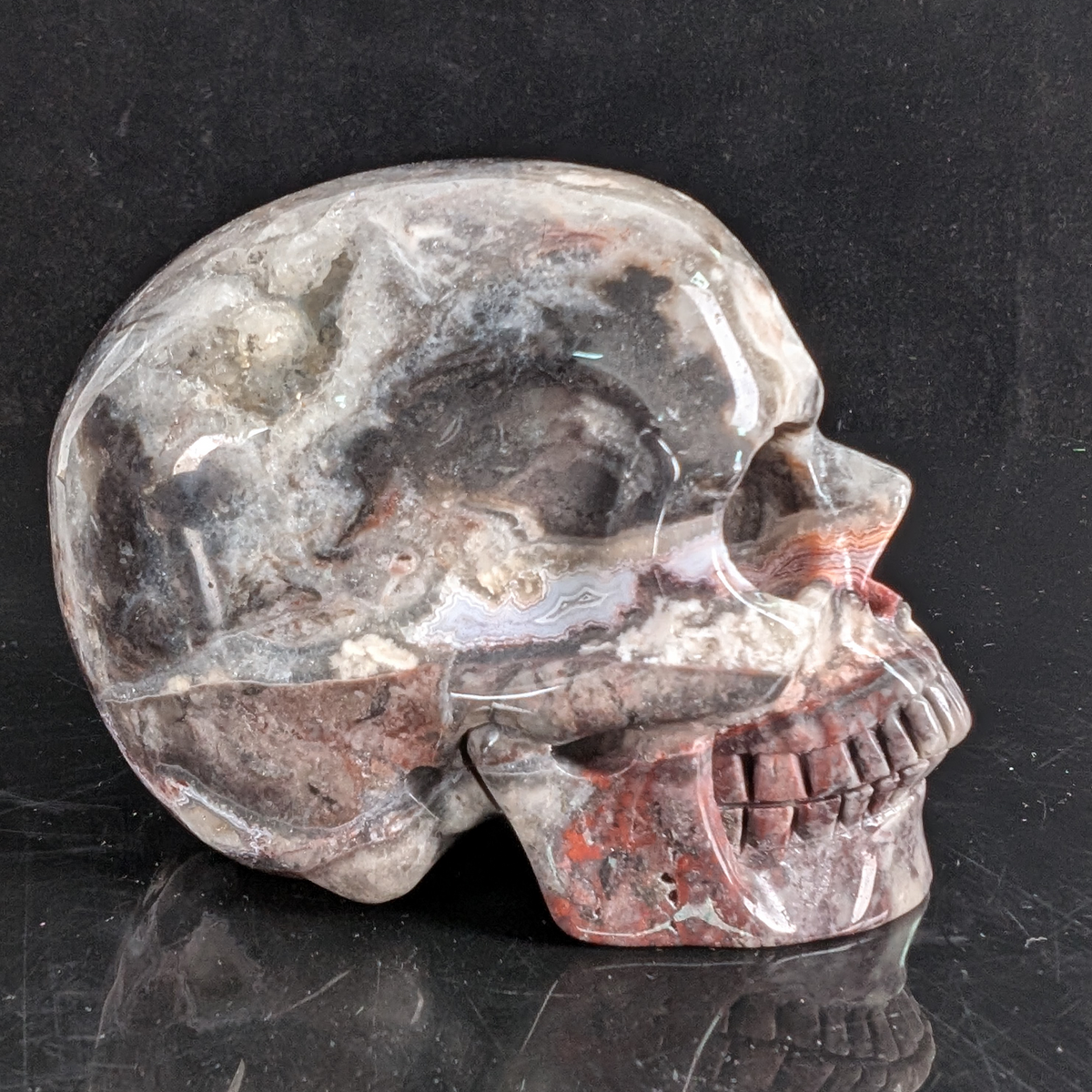 Right view of a 4.5-inch Red Crazy Lace Agate human skull carving