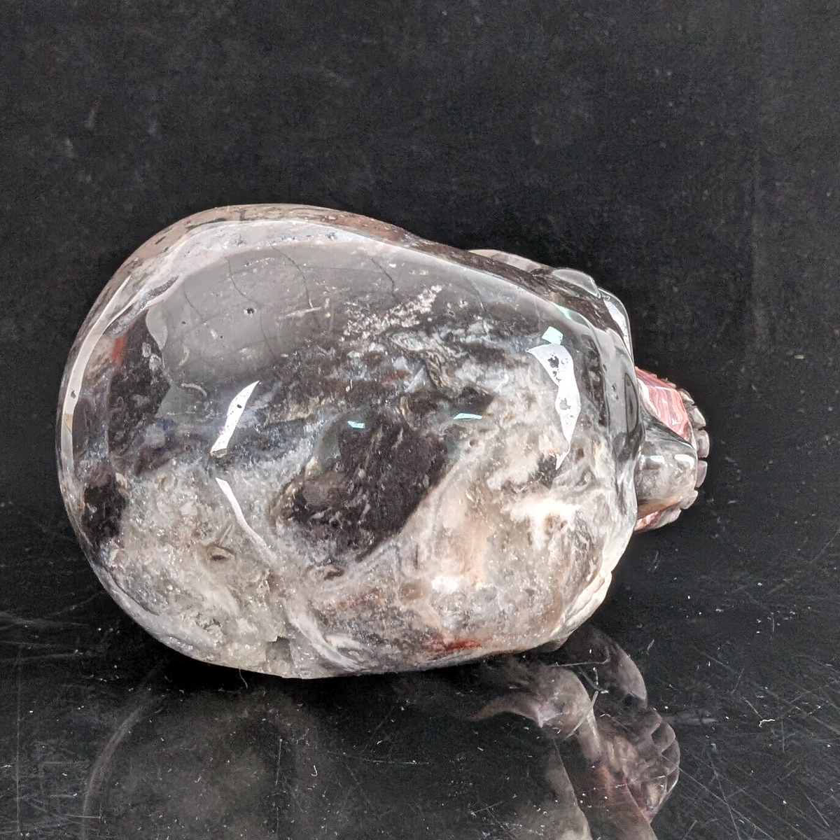 Top view of a 4.5-inch Red Crazy Lace Agate human skull carving