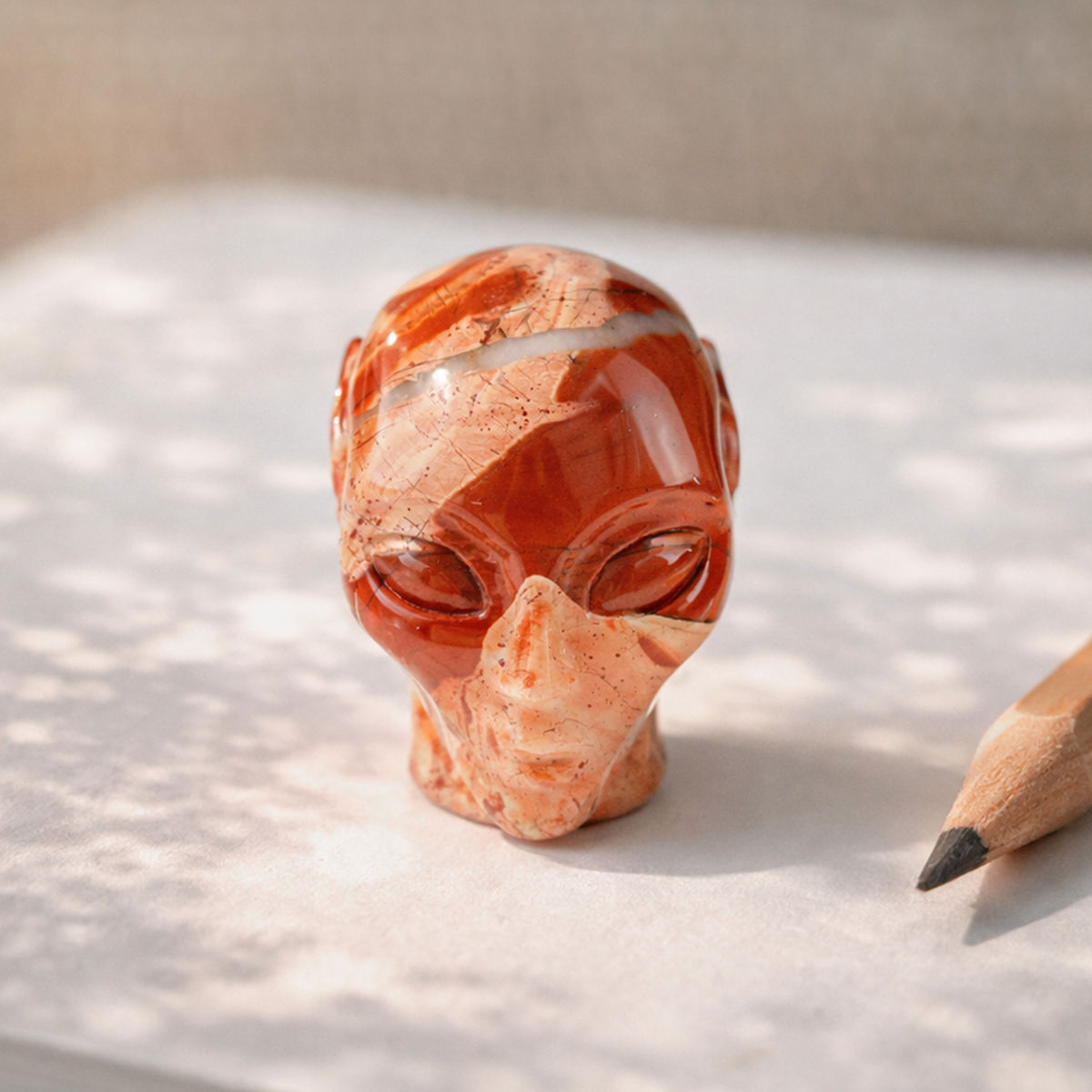 Additional view of a 2-inch Red Jasper alien skull carving