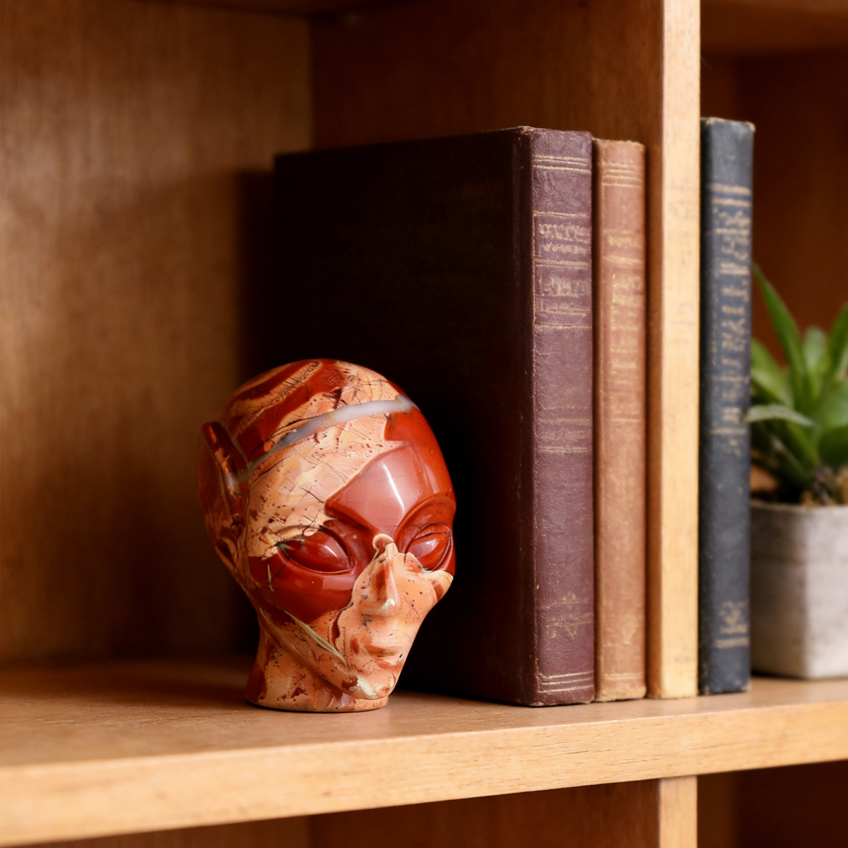 Additional view of a 3.8-inch Red Jasper alien skull carving