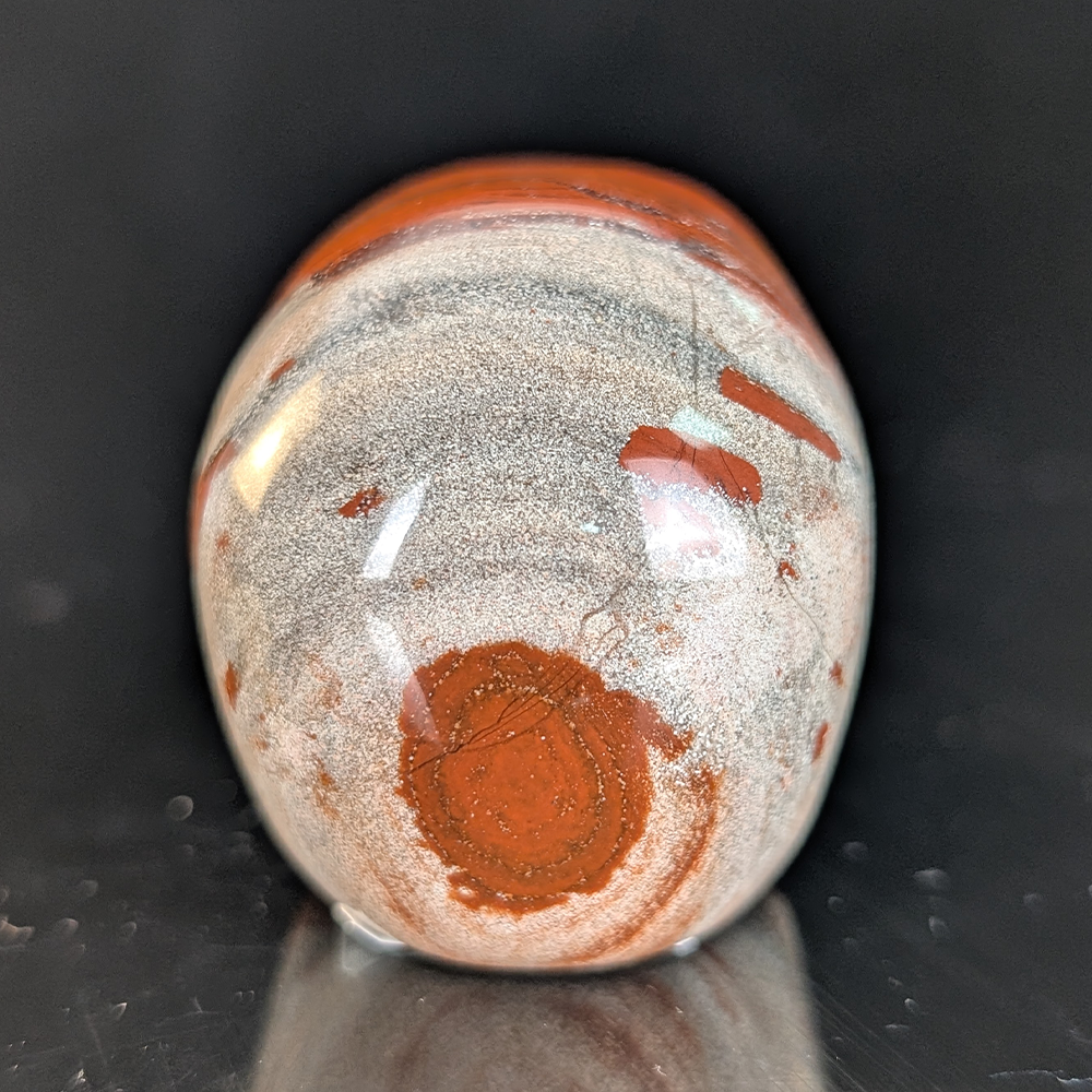 Back view of a 2-inch Red Jasper human skull carving