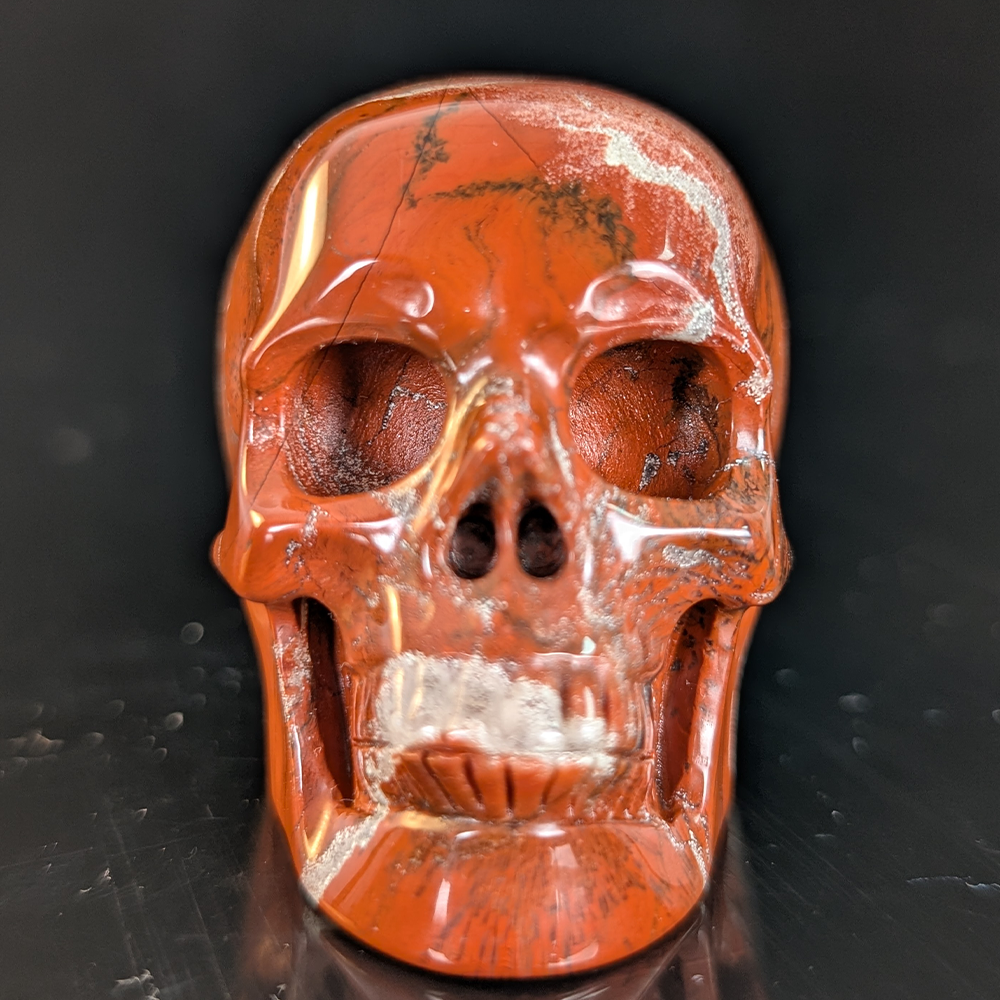 Front view of a 2-inch Red Jasper human skull carving