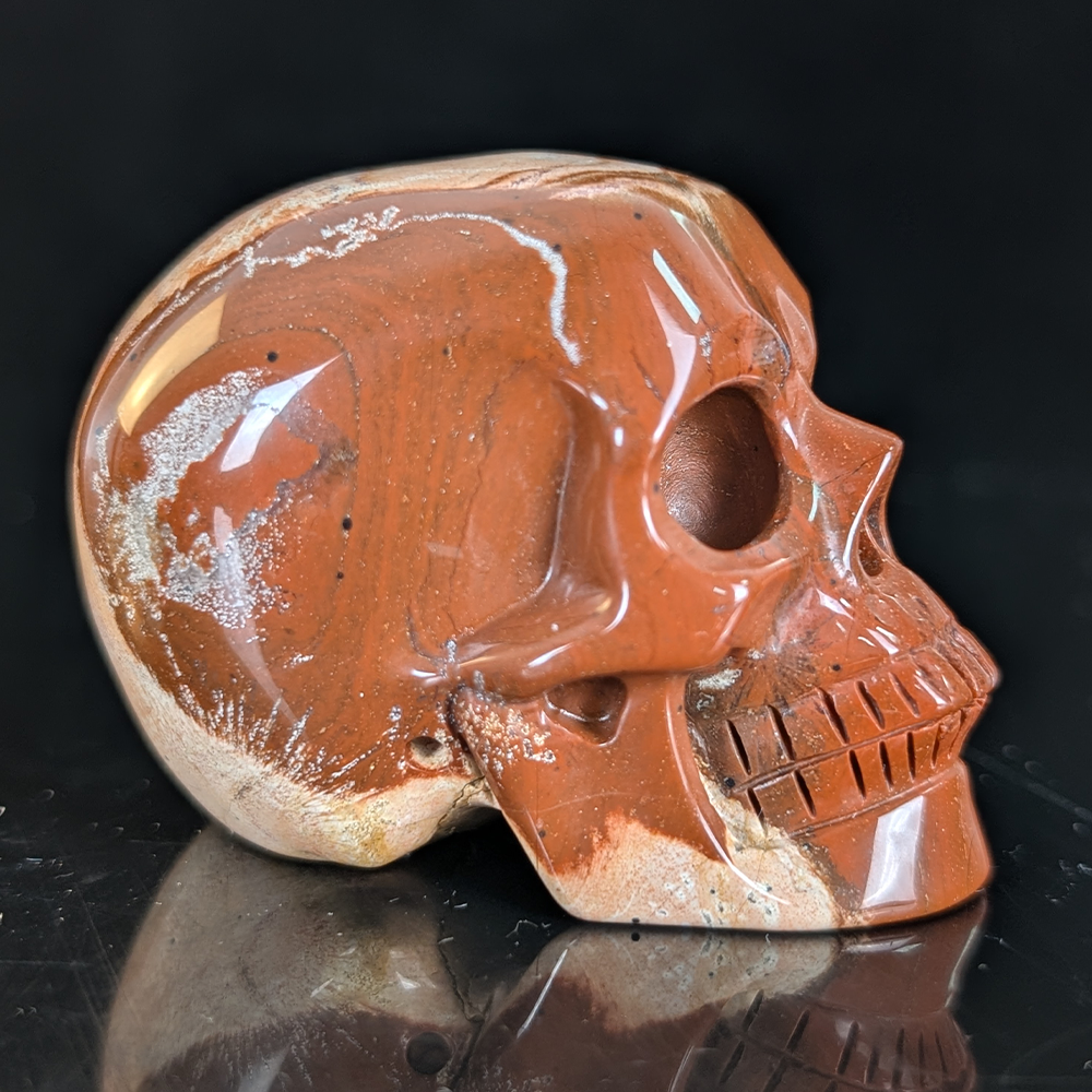Right view of a 2-inch Red Jasper human skull carving