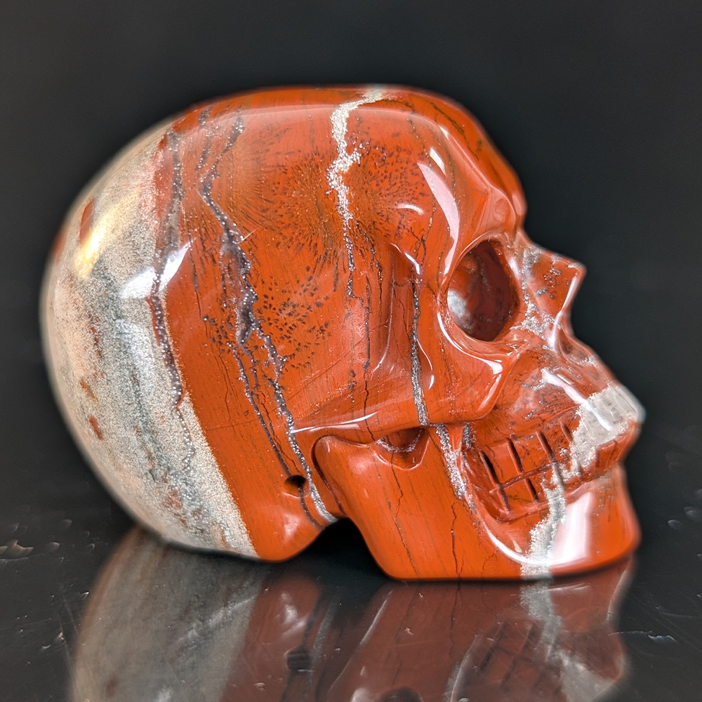 Right view of a 2-inch Red Jasper human skull carving
