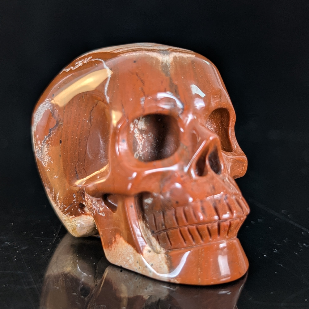 Right-front view of a 2-inch Red Jasper human skull carving