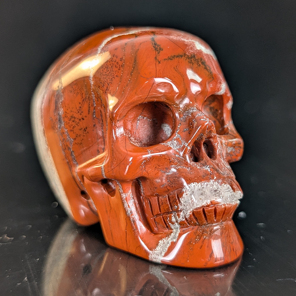 Right-front view of a 2-inch Red Jasper human skull carving