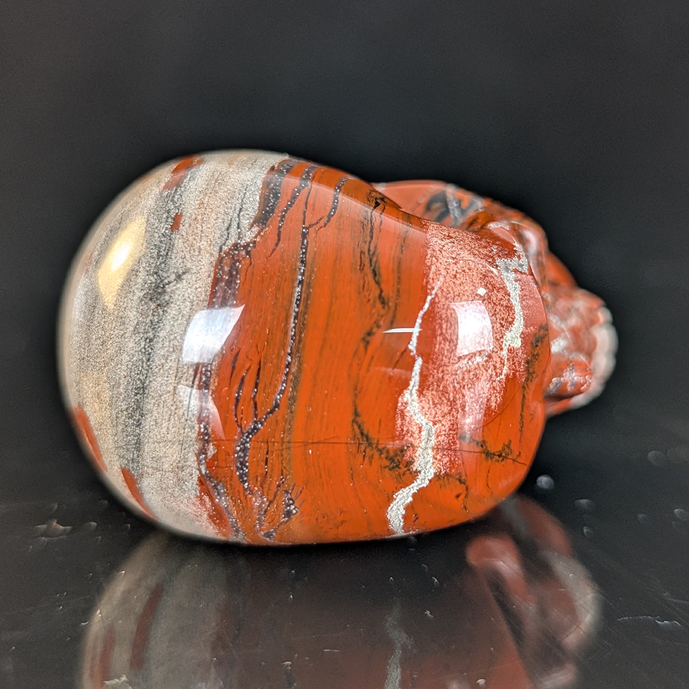 Top view of a 2-inch Red Jasper human skull carving