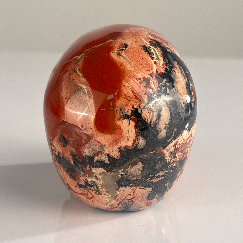 Back view of a 3-inch Red Jasper human skull carving