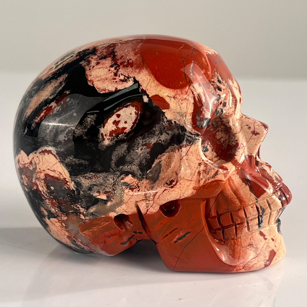 Right view of a 3-inch Red Jasper human skull carving
