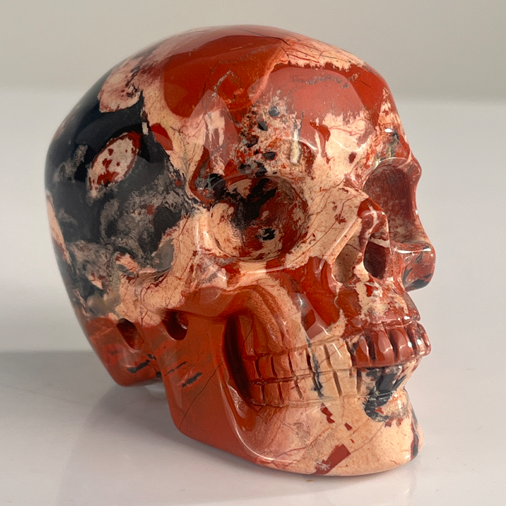 Right-front view of a 3-inch Red Jasper human skull carving