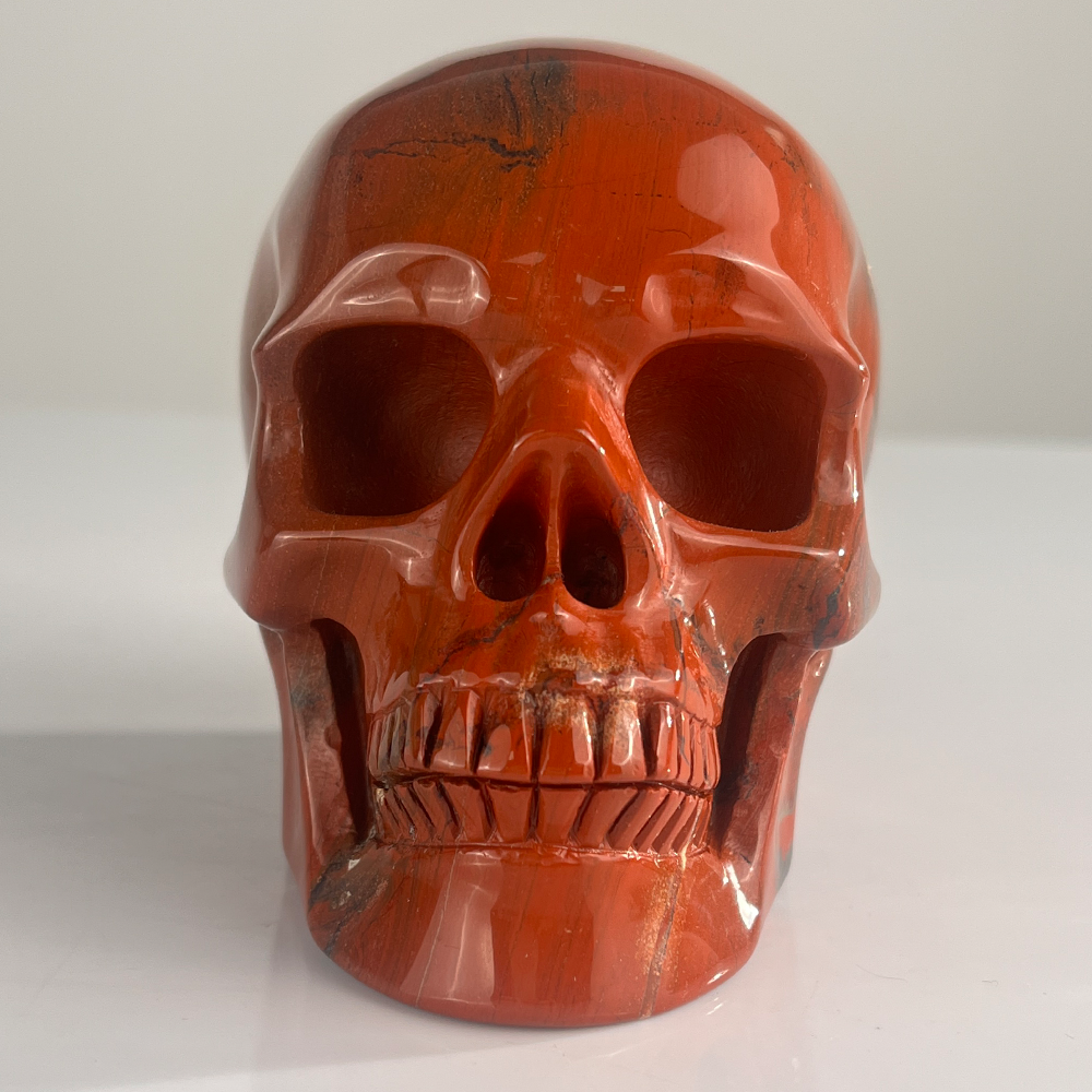 Front view of a 4.5-inch Red Jasper human skull carving