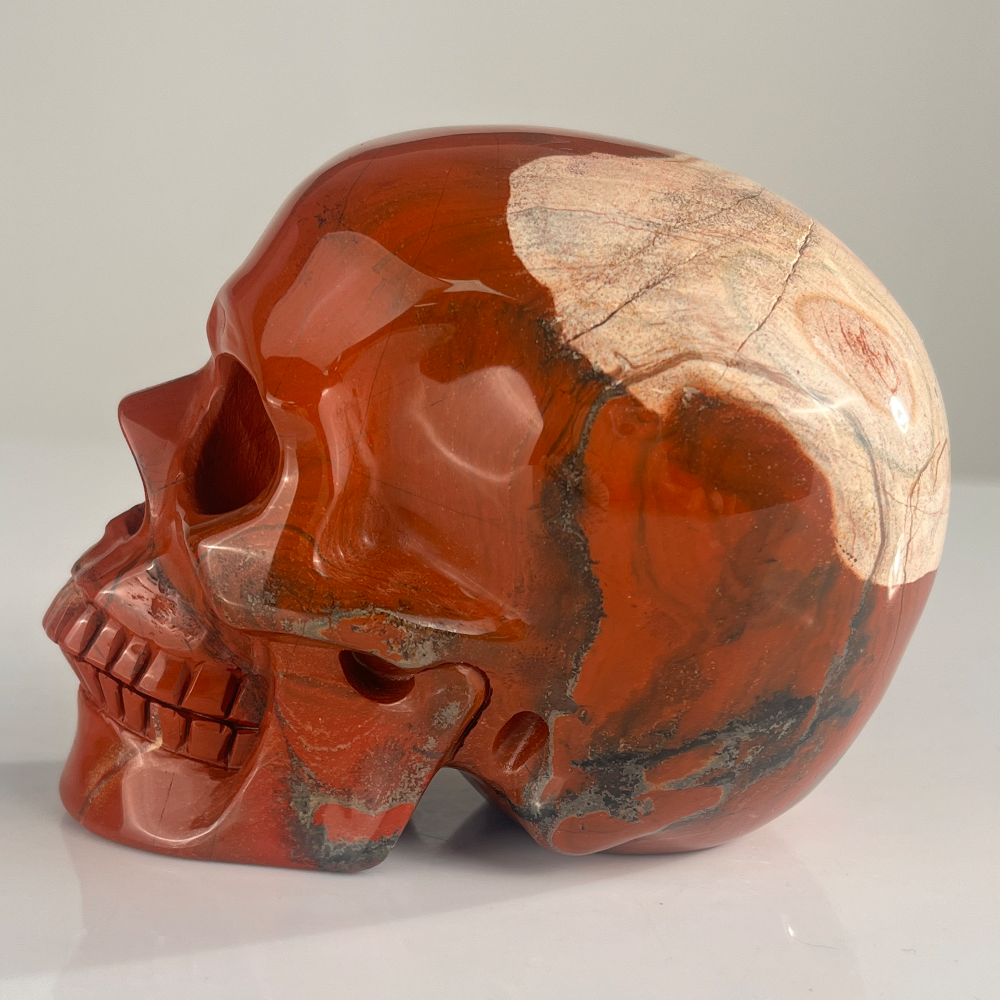 Left view of a 4.5-inch Red Jasper human skull carving
