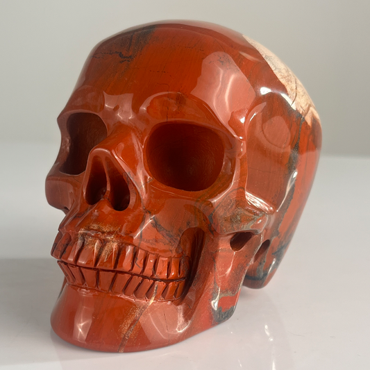 Left-front view of a 4.5-inch Red Jasper human skull carving