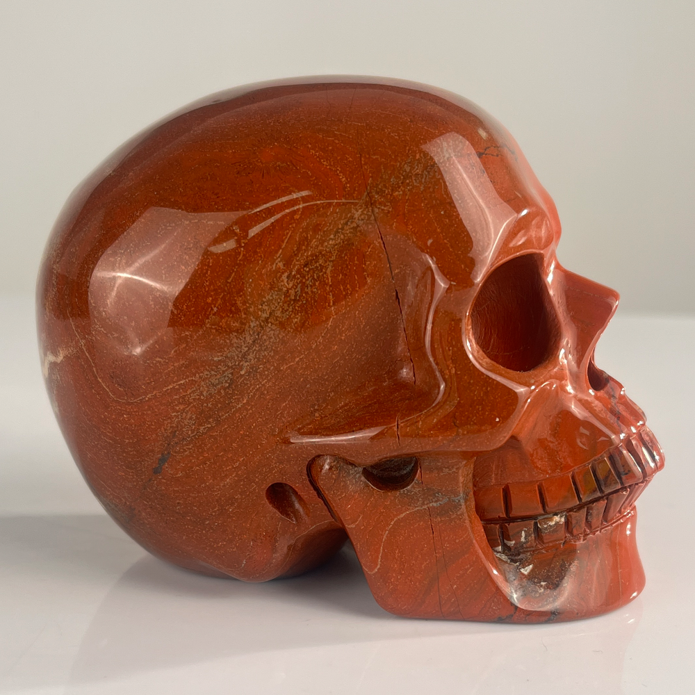 Right view of a 4.5-inch Red Jasper human skull carving