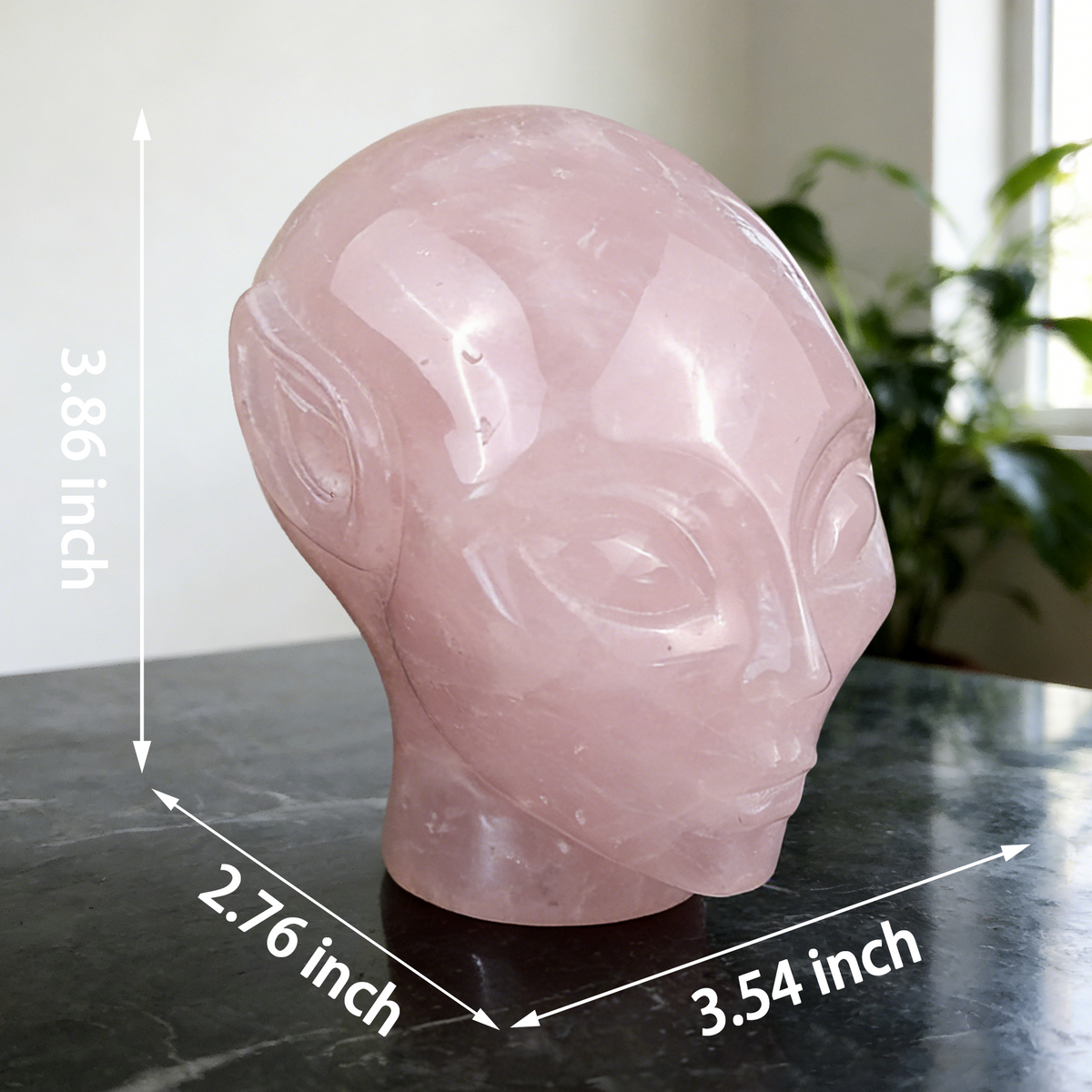 Additional view of a 3.8-inch Rose Quartz alien skull carving