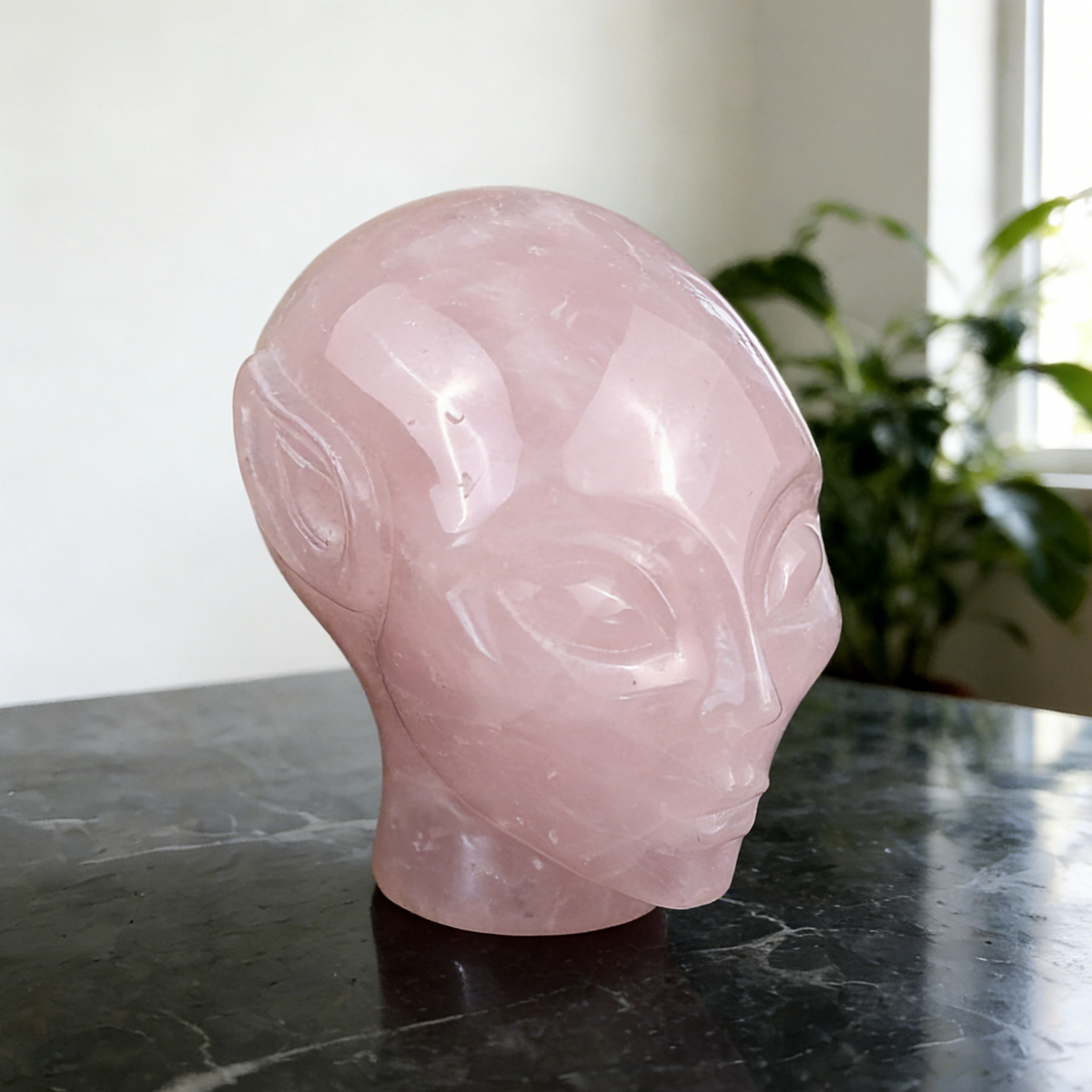 Additional view of a 3.8-inch Rose Quartz alien skull carving