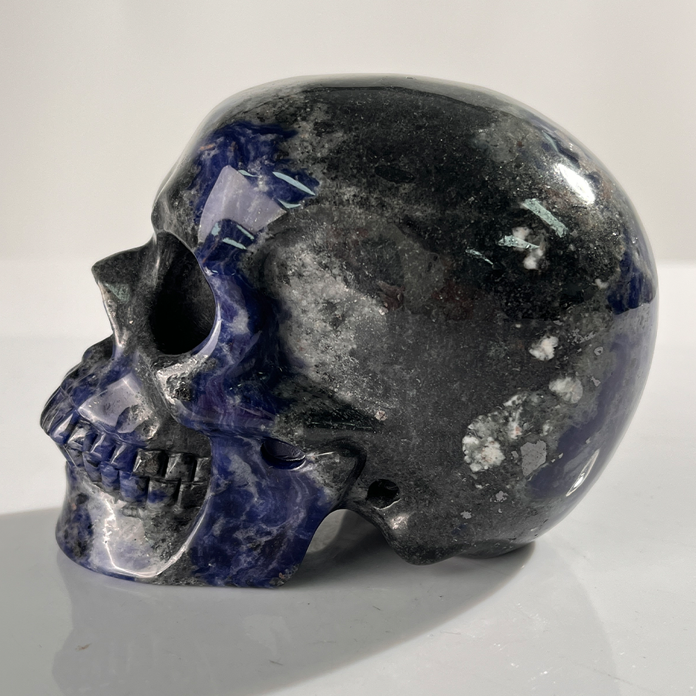 Left view of a 4.5-inch Sodalite human skull carving