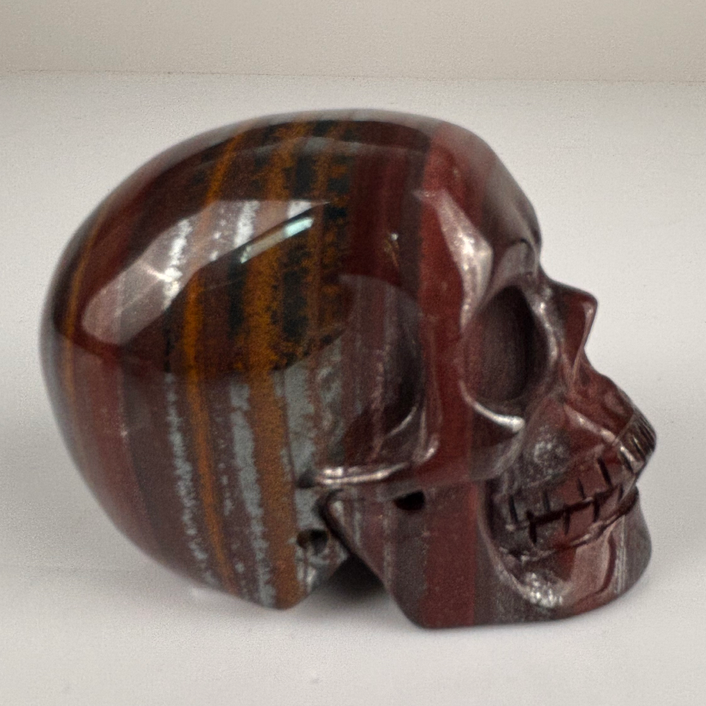 Right view of a 2-inch Tiger Iron human skull carving