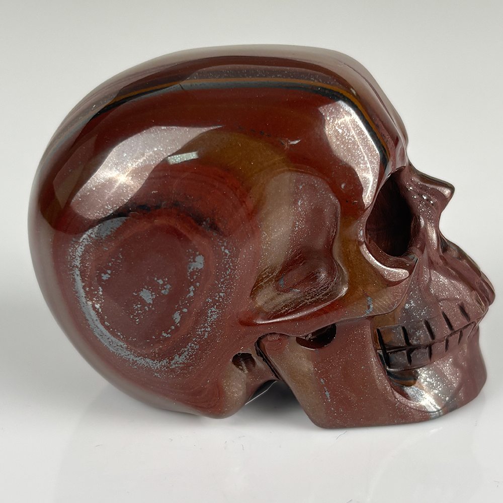 Right view of a 2-inch Tiger Iron human skull carving