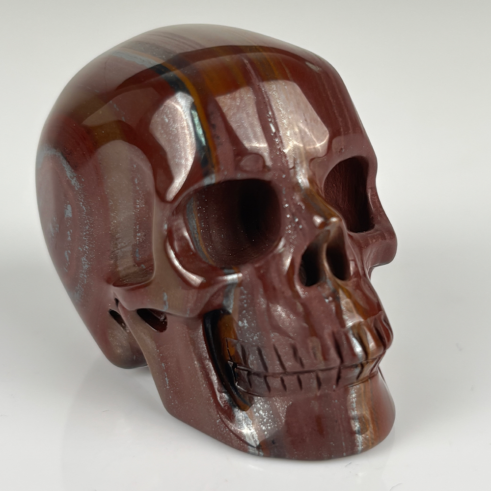Right-front view of a 2-inch Tiger Iron human skull carving