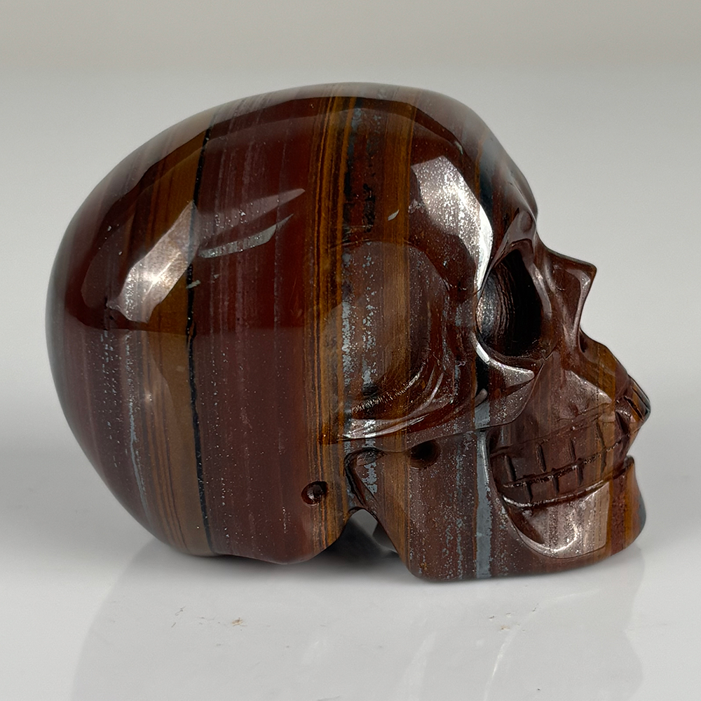 Right view of a 2-inch Tiger Iron human skull carving
