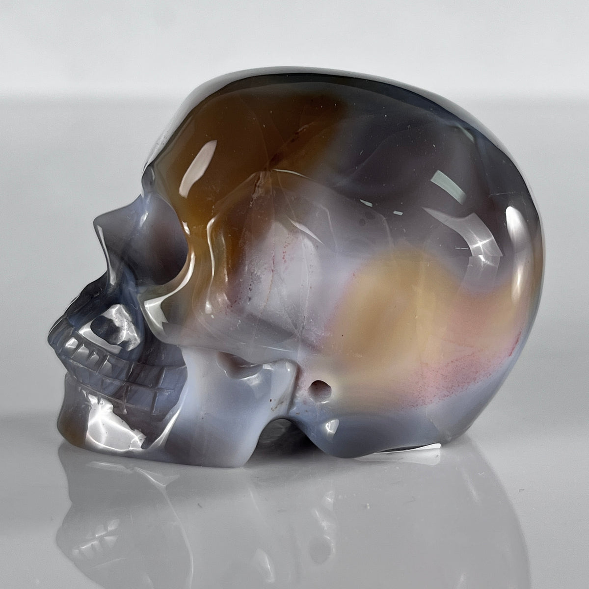 Left view of a 2-inch Volcanic Agate human skull carving
