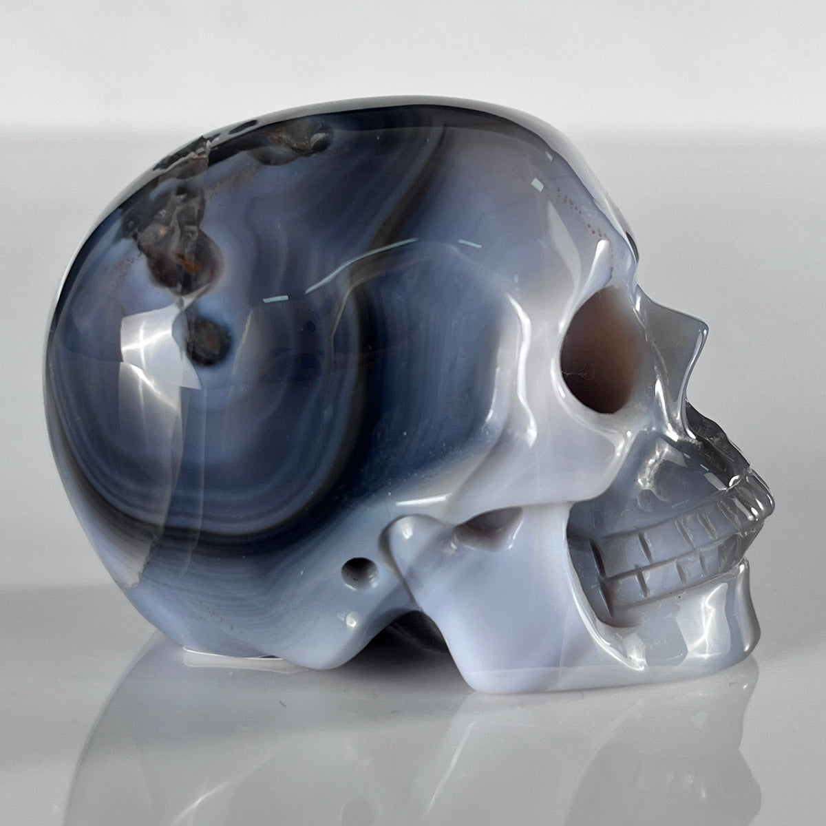 Right view of a 2-inch Volcanic Agate human skull carving