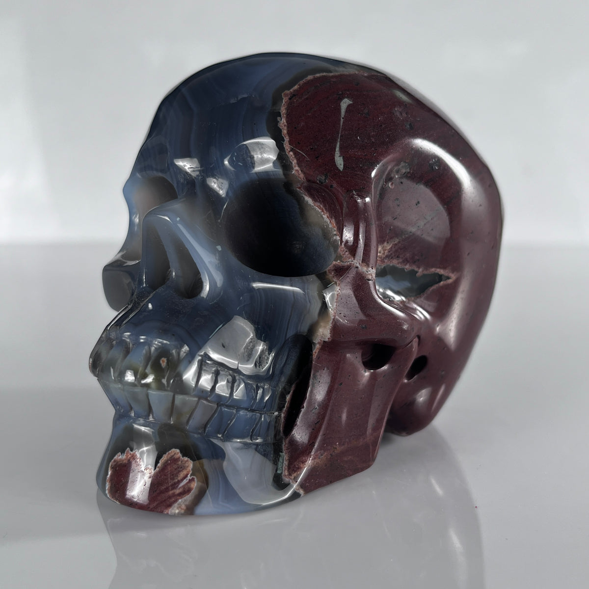 Left-front view of a 4.5-inch Volcanic Agate human skull carving