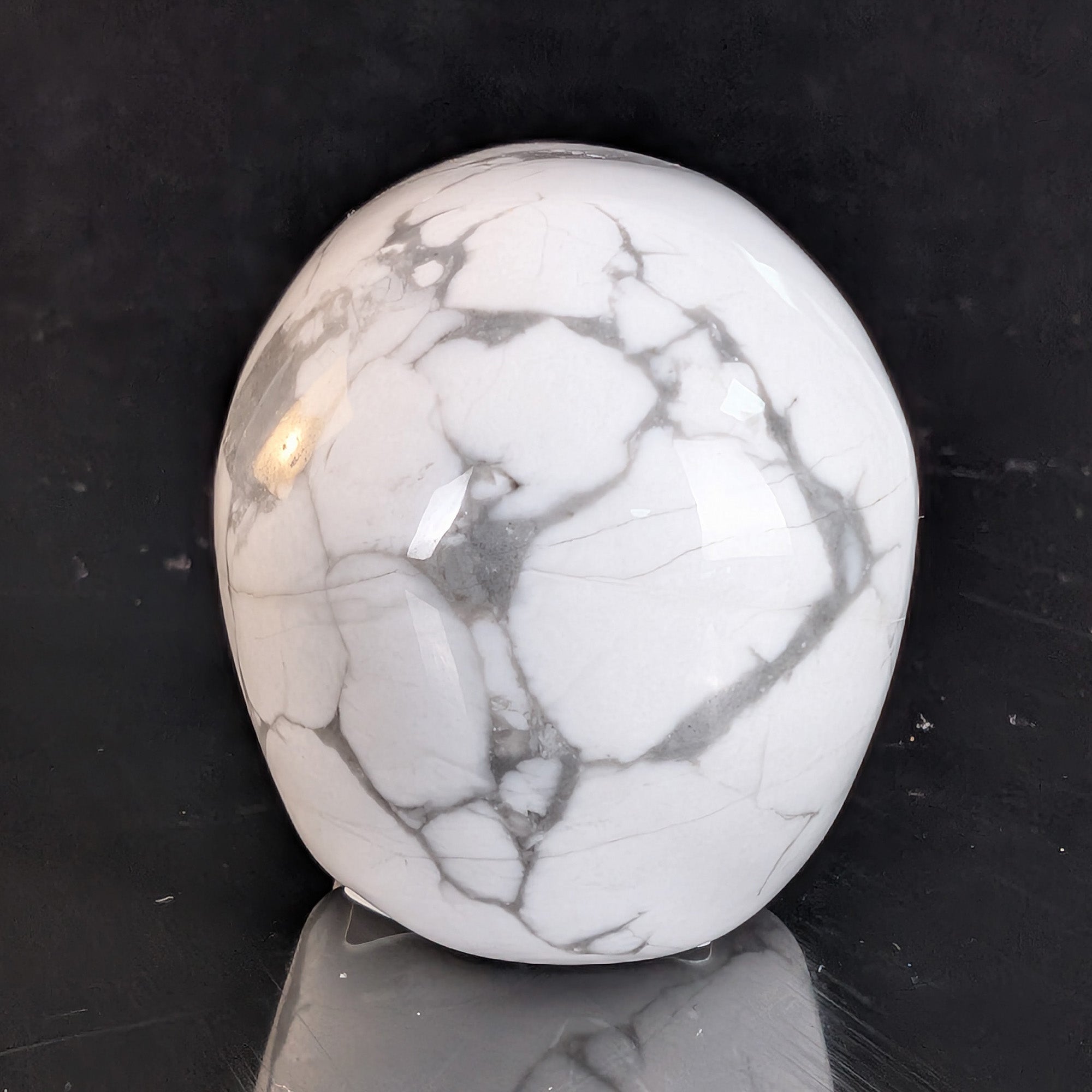 Back view of a 2-inch White Howlite human skull carving