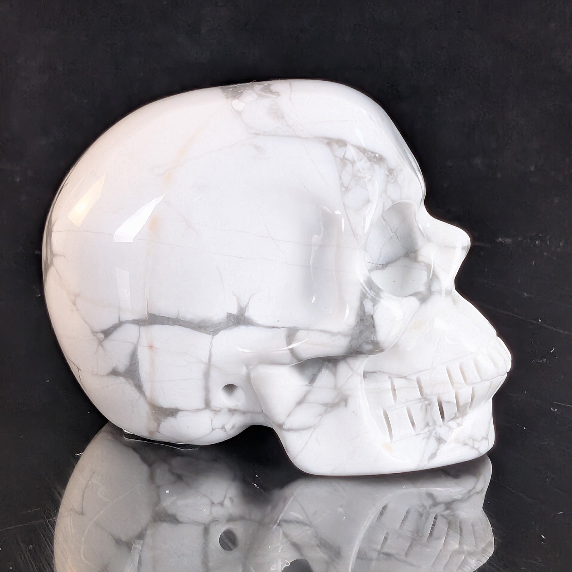 Right view of a 2-inch White Howlite human skull carving