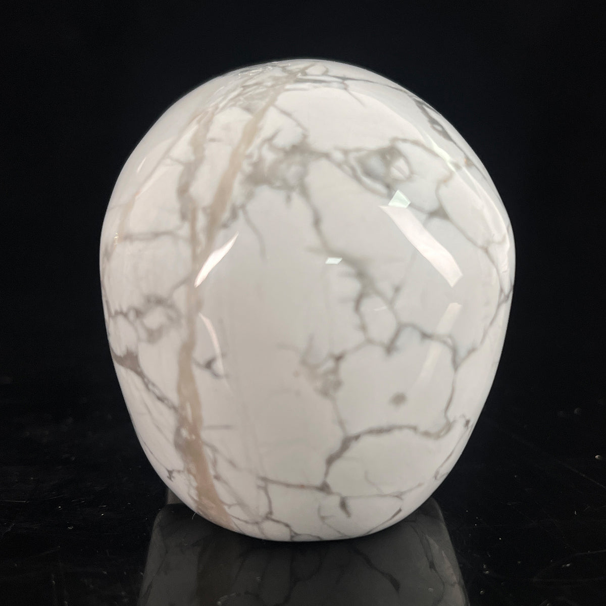 Back view of a 3-inch White Howlite human skull carving
