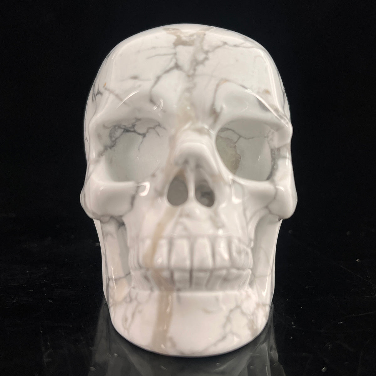 Front view of a 3-inch White Howlite human skull carving