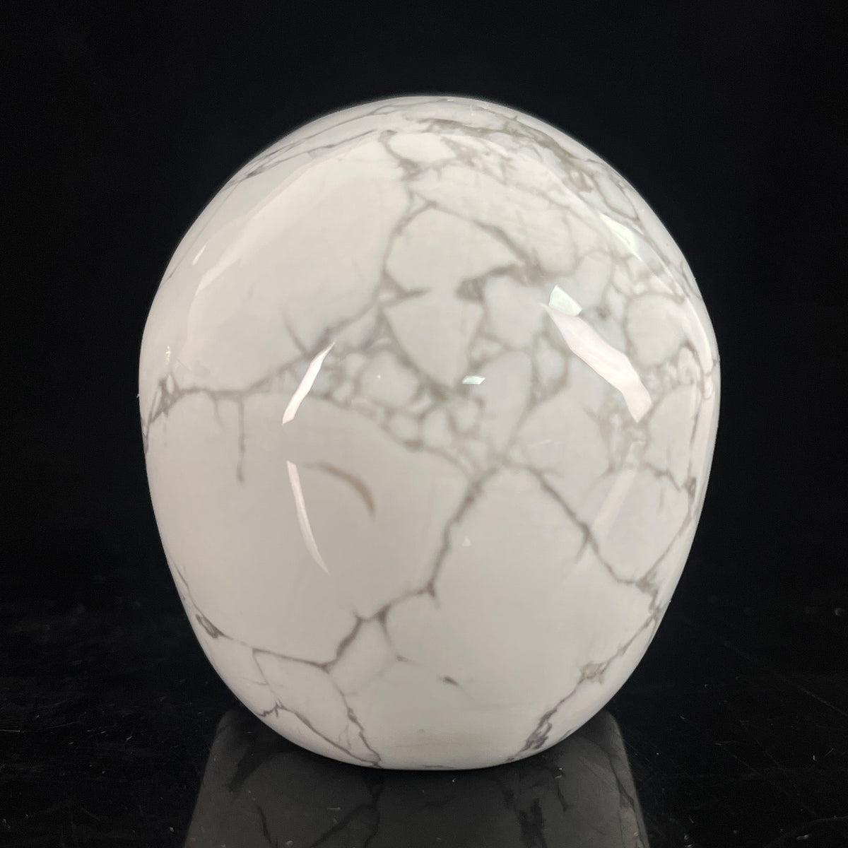 Back view of a 3-inch White Howlite human skull carving