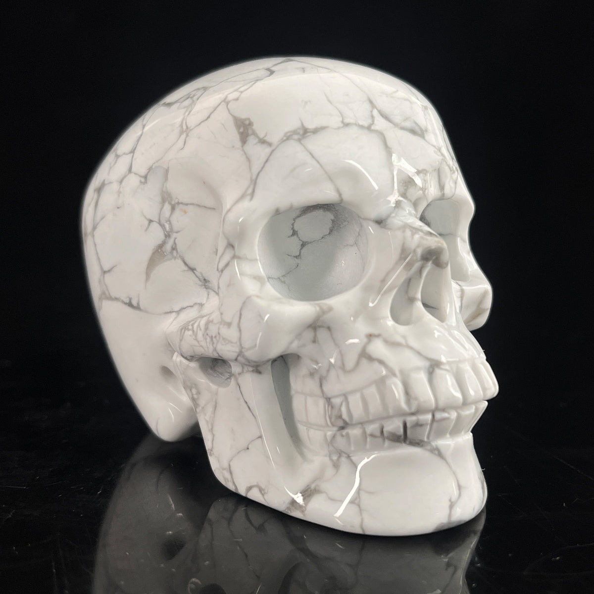 Right-front view of a 3-inch White Howlite human skull carving