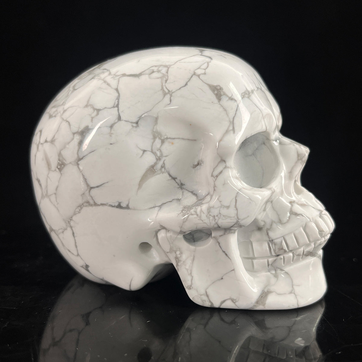 Right-side view of a 3-inch White Howlite human skull carving