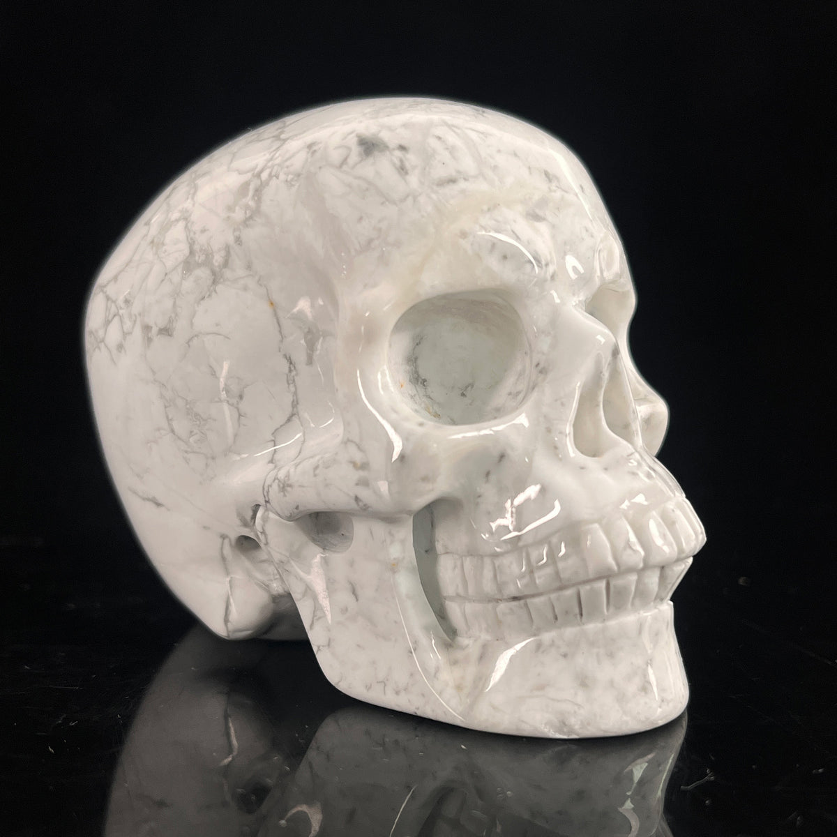 Right-front view of a 3-inch White Howlite human skull carving