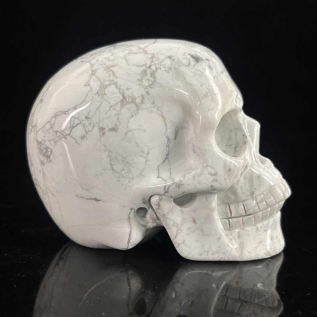 Right-side view of a 3-inch White Howlite human skull carving