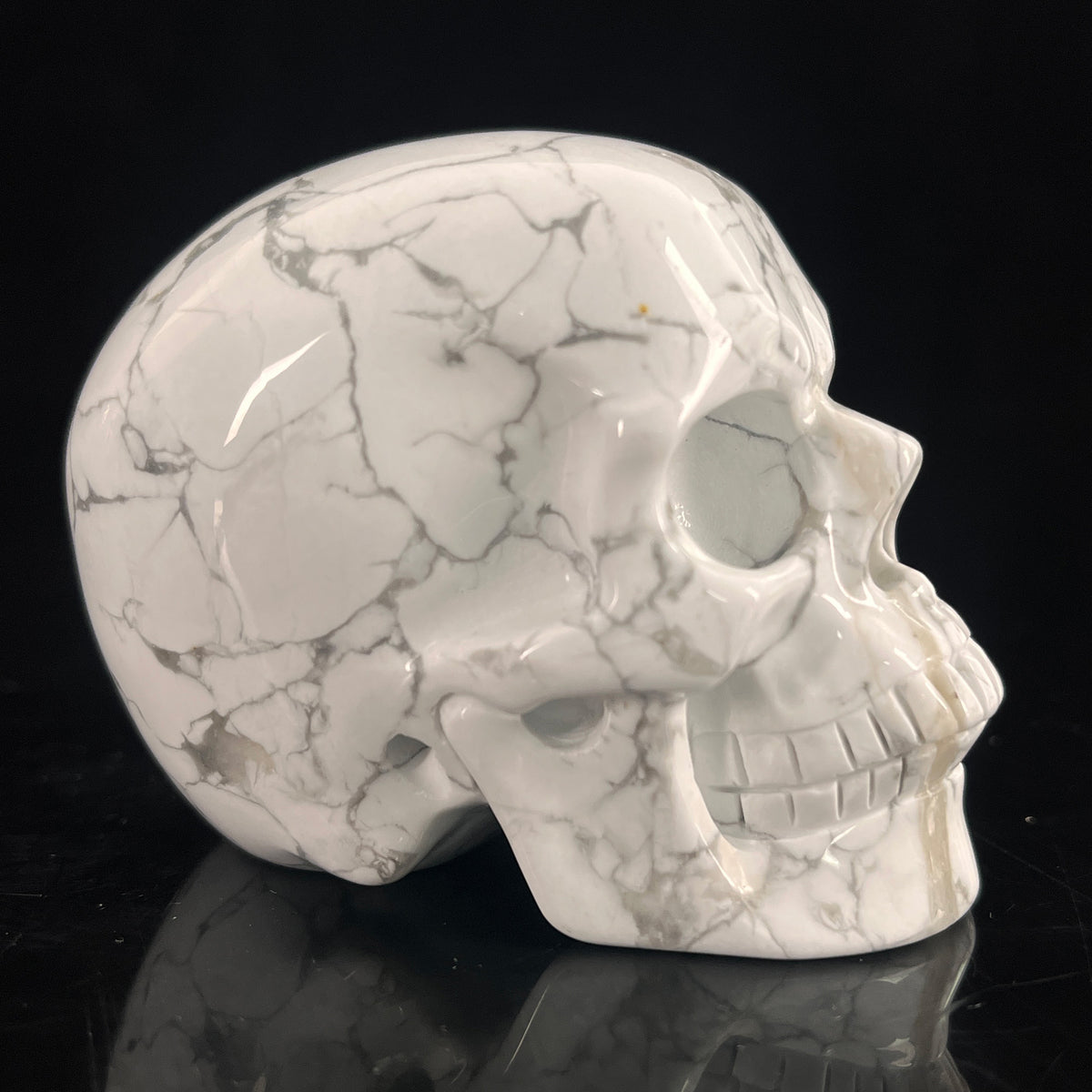 Right view of a 3-inch White Howlite human skull carving