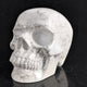 Left-front view of a 4.5-inch White Howlite human skull carving