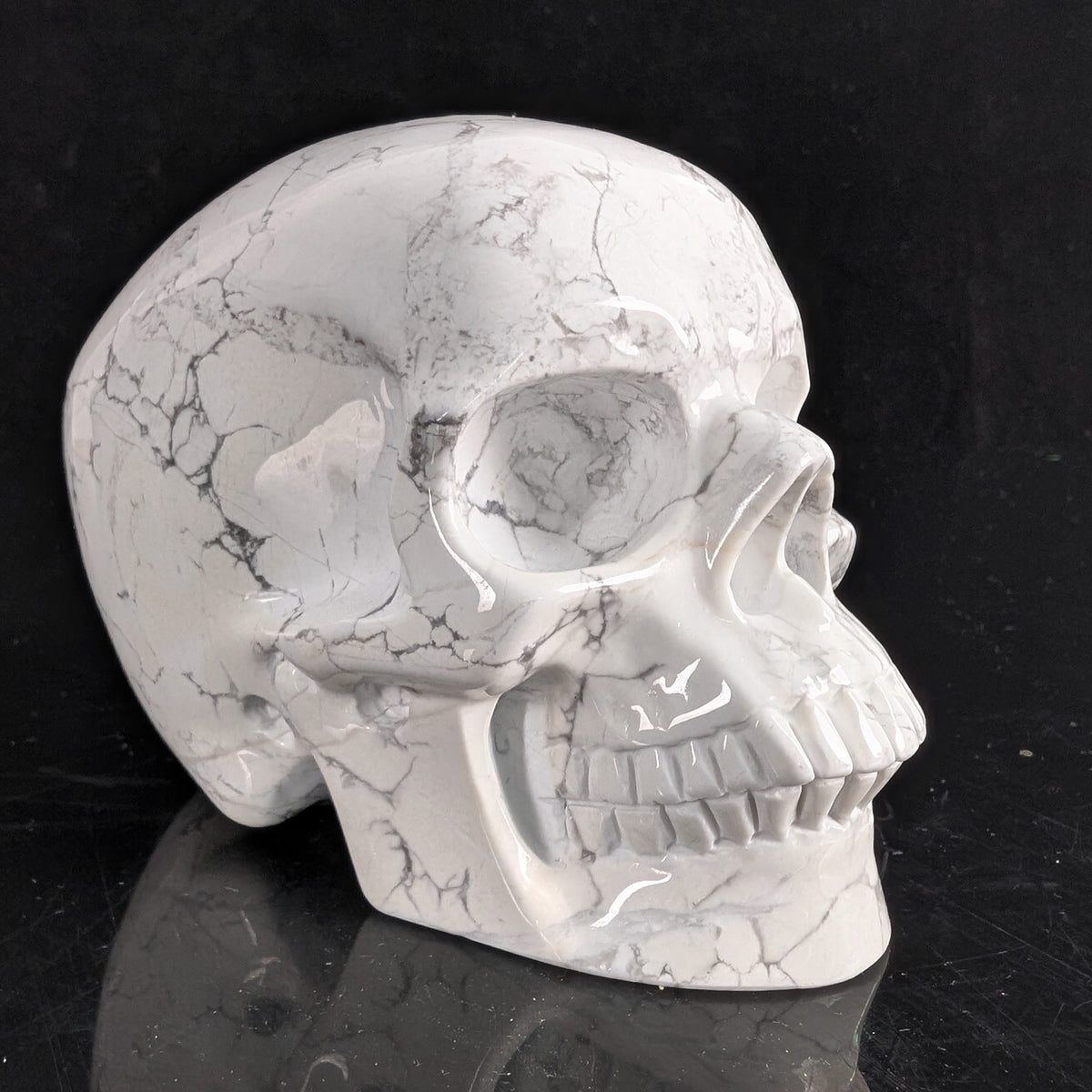 Right-front view of a 4.5-inch White Howlite human skull carving