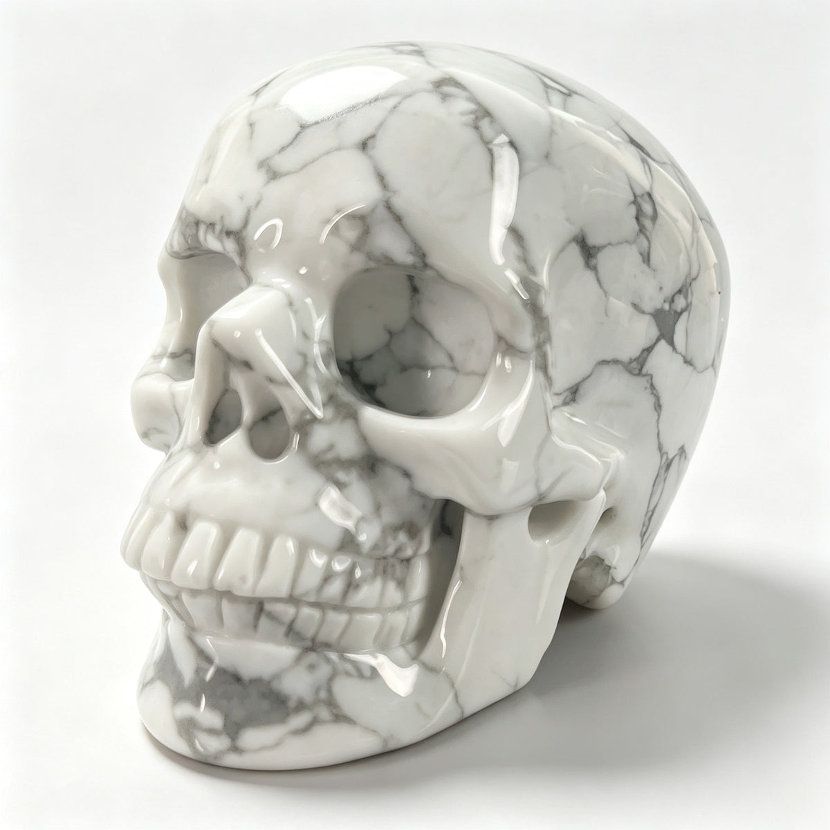 Left-front view of a 3-inch White human skull carving
