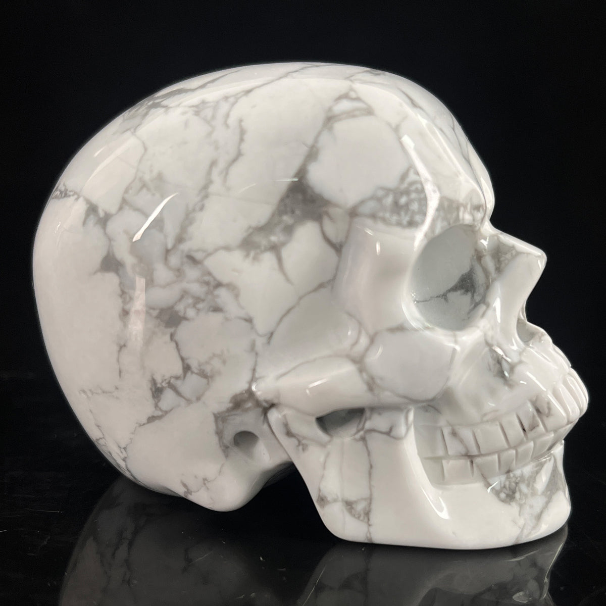 Right view of a 3-inch White human skull carving